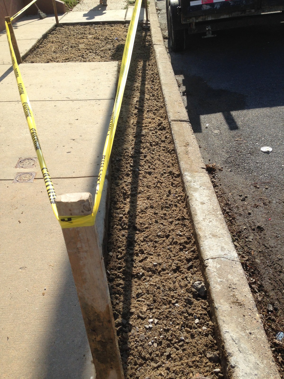 Before: curb strip dug out and prepped for new concrete